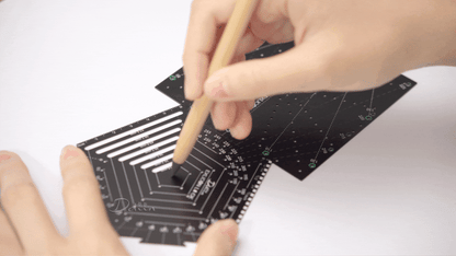 Demonstration on drawing one point perspective with black pentagon tool and black square tool on white paper