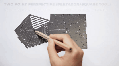 Demonstration on drawing two point perspective with black pentagon tool and black square tool on white paper