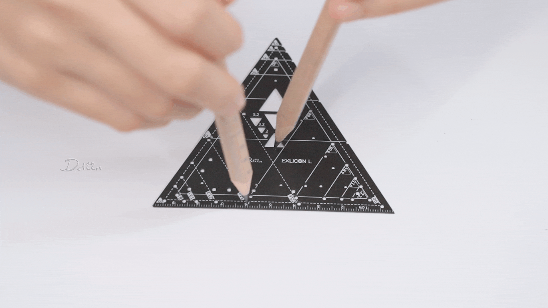 Demonstration of drawing circles with different radius on black triangle ruler