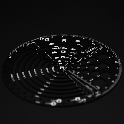 Black circular ruler with measurement markings for perfect golden ratio on a black background