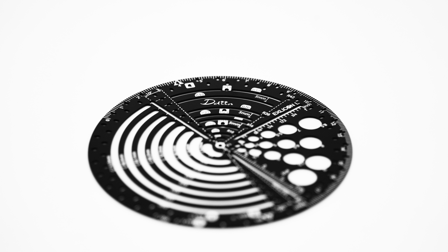 Black circular ruler with measurement markings for perfect golden ratio on a white background