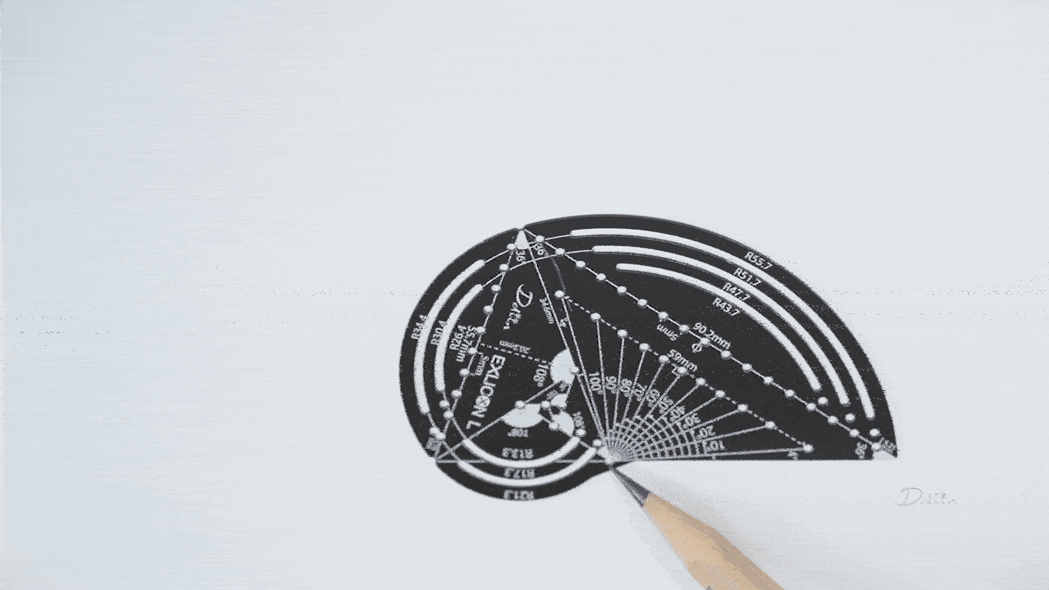 Demonstration of drawing golden ratio triangles with black parabola compass with measurement markings