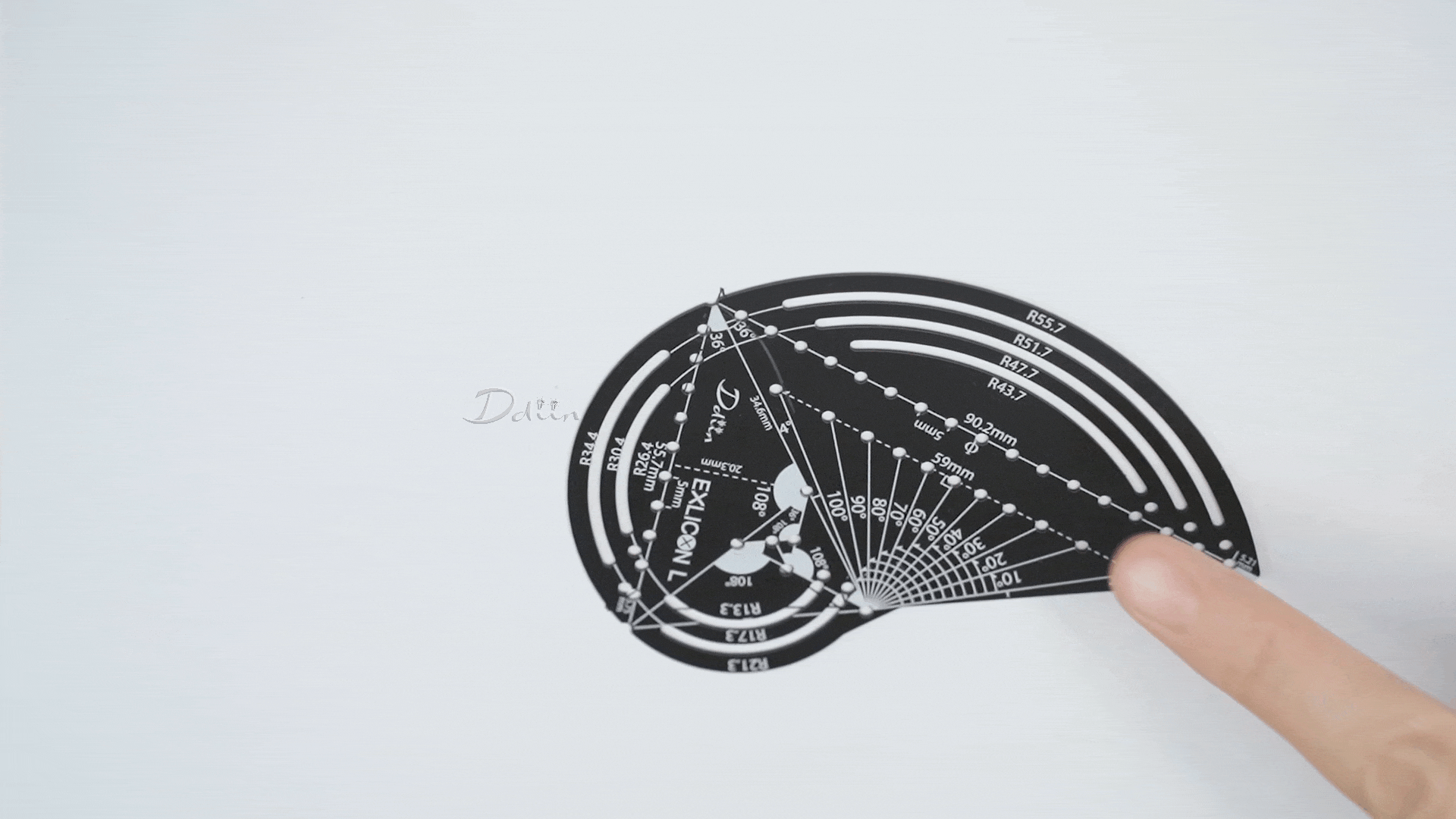 Demonstration of drawing golden ratio triangles with black geometric compass with measurement markings