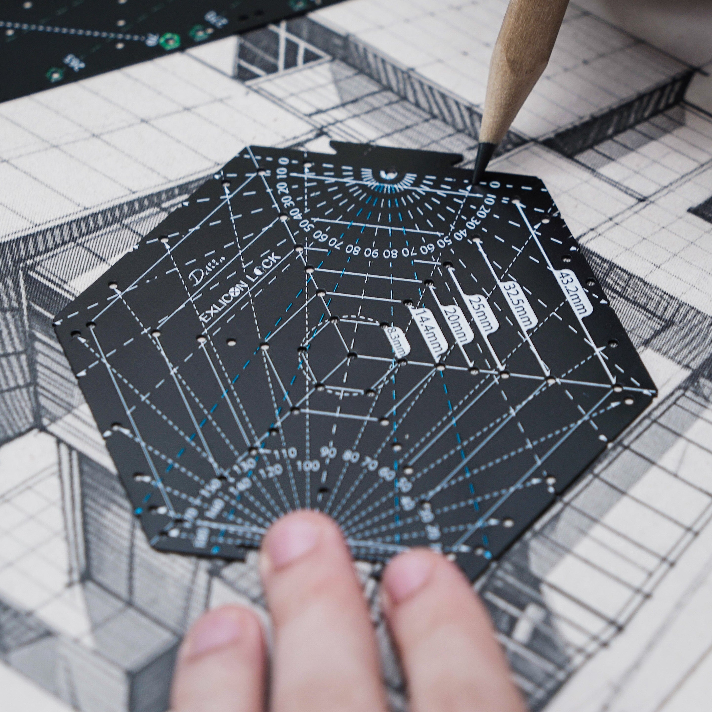 Person holding a black hexagon tool with measurement markings drawing architecture design