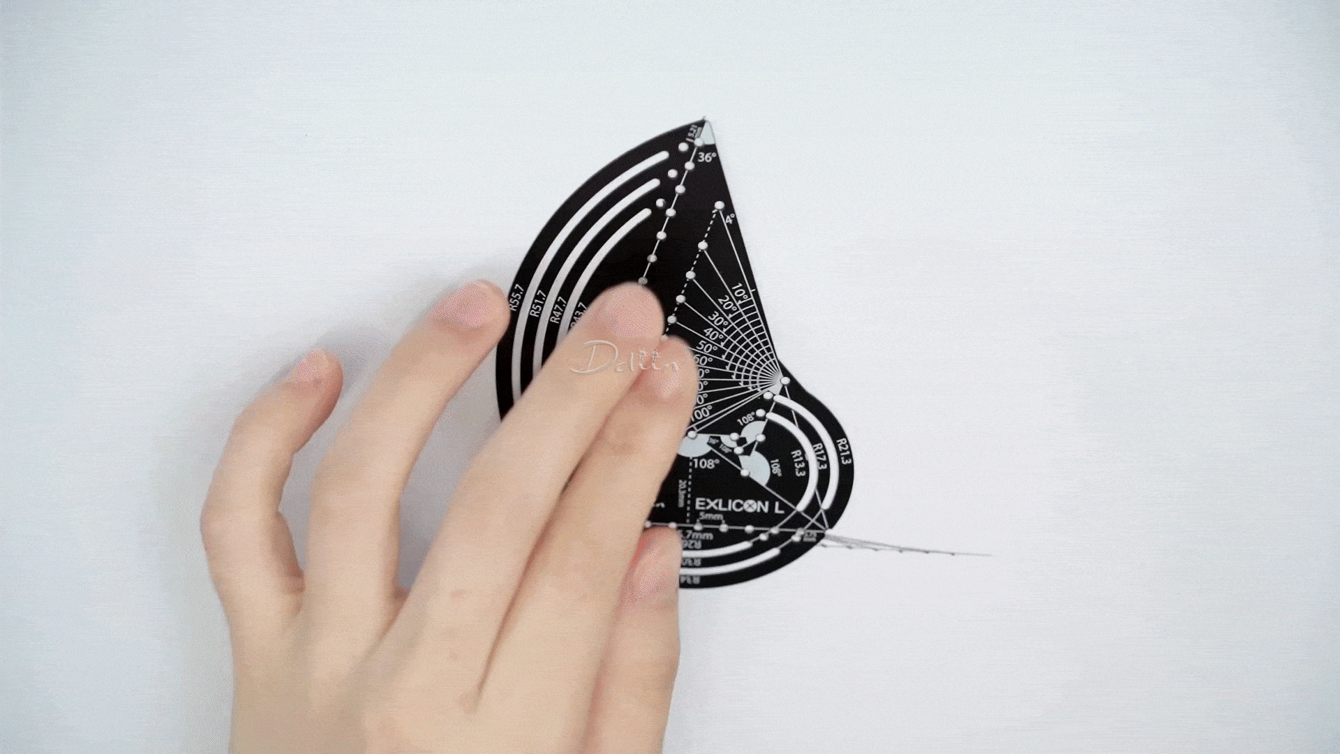 Demonstration of drawing parabolic lines with black golden ratio compass with measurement markings 