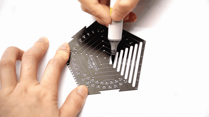 Demonstration on drawing lines with different lengths with black pentagon tool on white paper